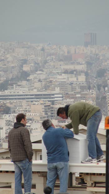 Some repairmen working on a roof. Athens Greece March 2010