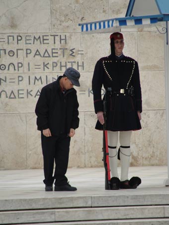 a tourist looking at the greek guard, athens